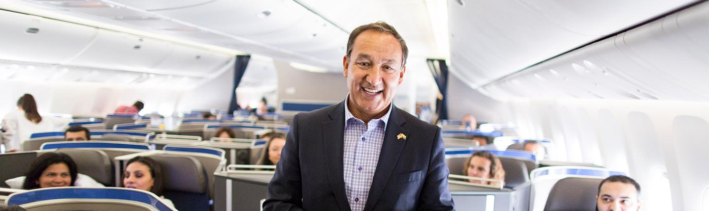 Oscar Munoz standing in an airplane