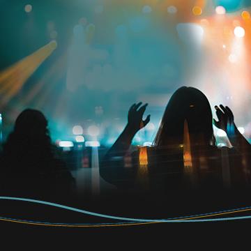 Students worshipping in front of a stage