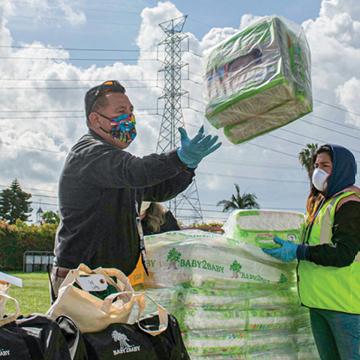 Workers unloading diapers from a truck delivery