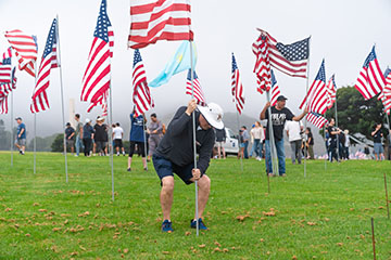 President Jim Gash inserted flag pole in ground