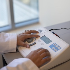A practitioner operates a medical device