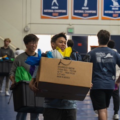 A student carries a box of care packages
