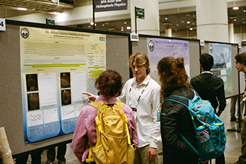 Seaver physics student explaining dynamics of daytime-occuring auroras