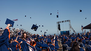 Graduates from Seaver College's Class of 2020 toss their hats at their commencement ceremony.