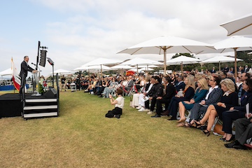 Quaid speaking to a crowd
