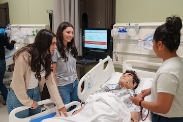 Pepperdine students and a training mannequin
