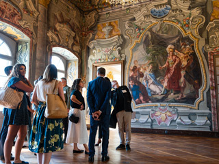 Visitors looking at murals