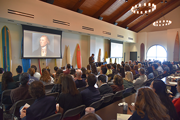 Larson addressing the audience