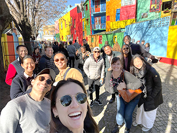 Faculty pose together on the colorful streets of Buenos Aires
