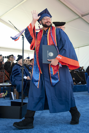 Student at graduation wearing military honor cords