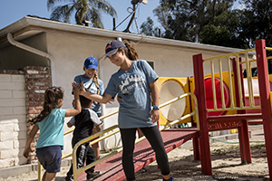 Students play with children after school as part of Step Forward Day