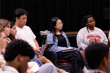 Student actors participating in the rehearsal discussion