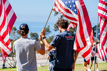Student athletes placing flags