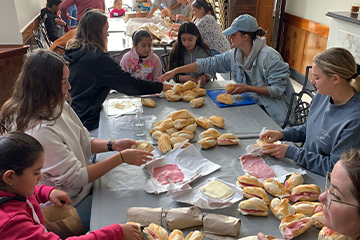 Students making sandwiches with the children