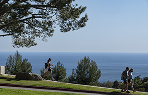 Students walk along path overlooking ocean view