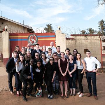 Law Students posing in front of a prison in Uganda with Danny DeWatt.