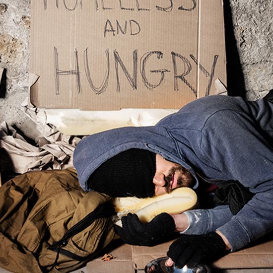 Homeless man sleeping on the ground