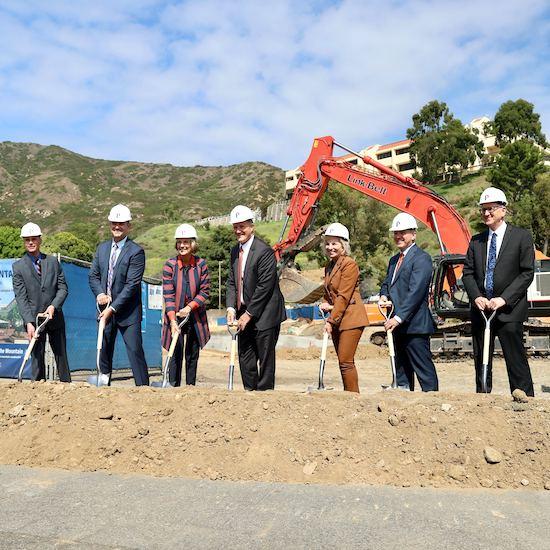 Group holding shovels at groundbreaking ceremony