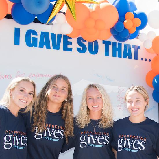 Four female students in Pepperdine Gives t-shirts