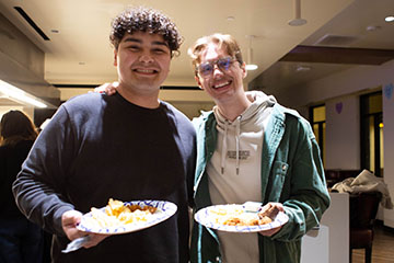 two students holding plates