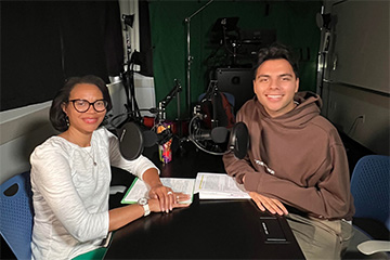 two people hosting podcast with. microphones