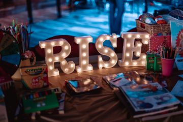 RISE letters on a table