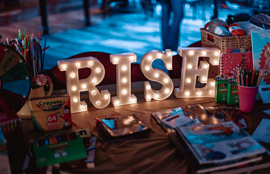 RISE spelled out in lights