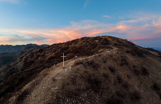 crosses on a mountain at sunset