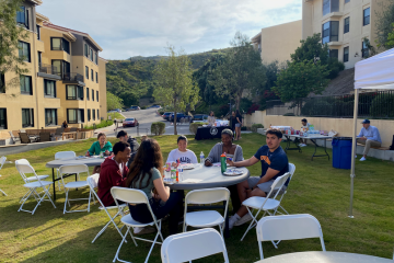 Students playing bingo outside.