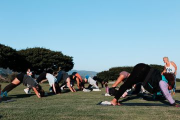 Students doing yoga outside