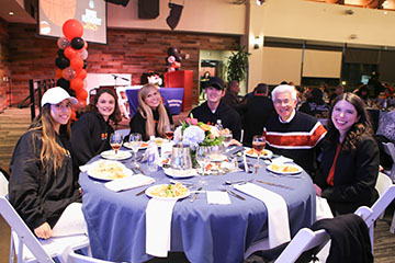 people sitting around a table eating