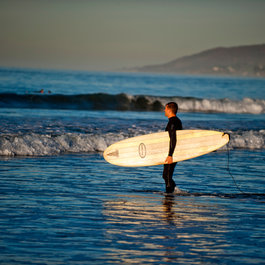 surfer standing in ocean