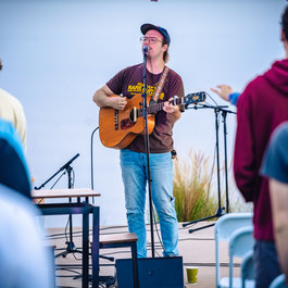 Student singing with his guitar