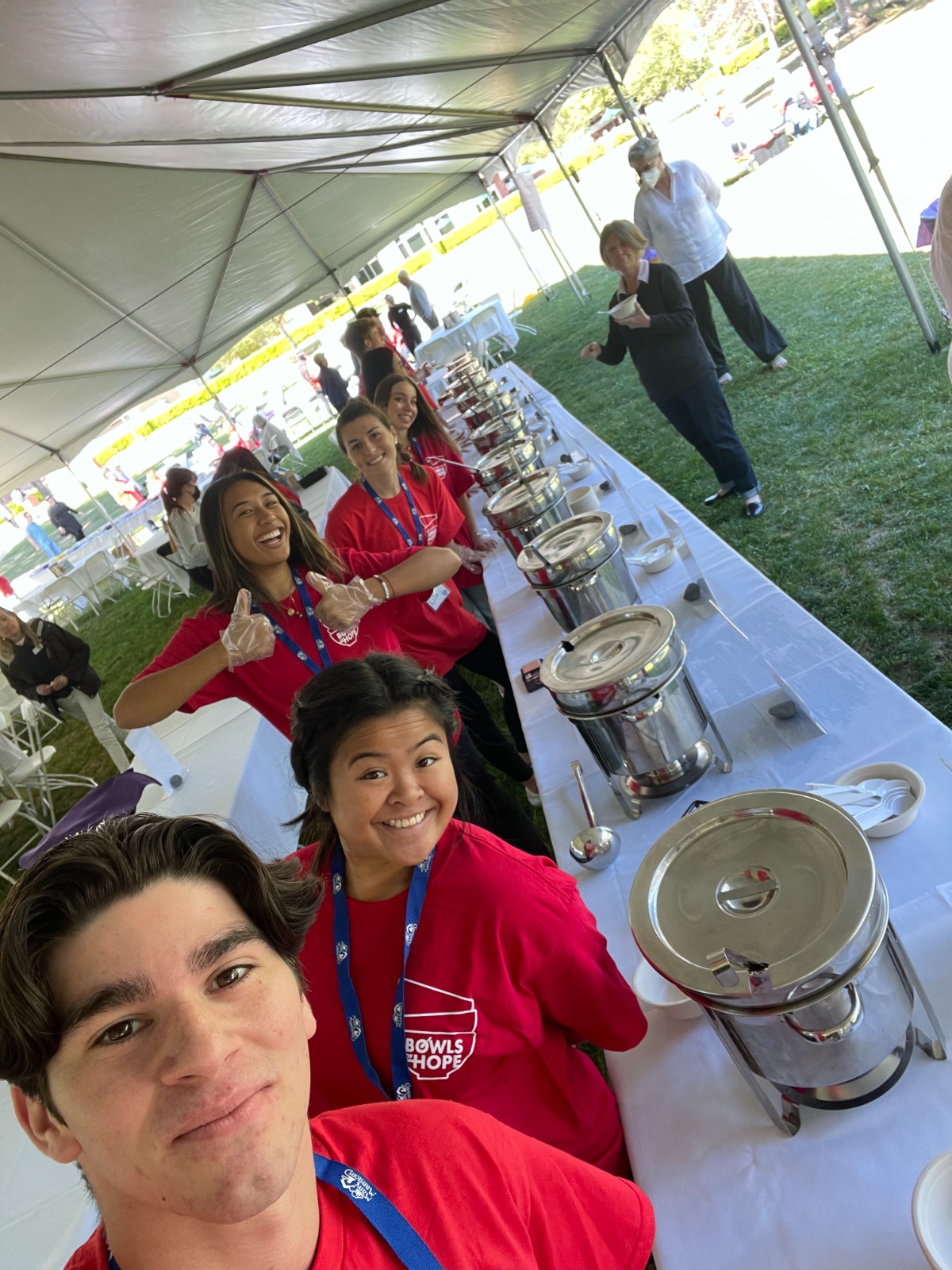 Student volunteers posing with food bins