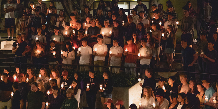 Students worship at a candlelight service