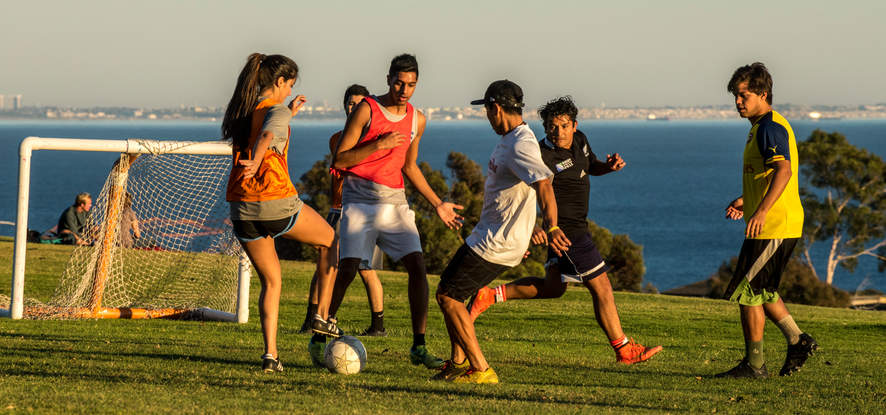 Students playing soccer on Alumni Park