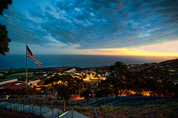 Sunset with view of ocean and American flag