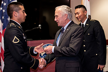 Veteran shaking hands with man