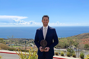 John Powers holding George Award