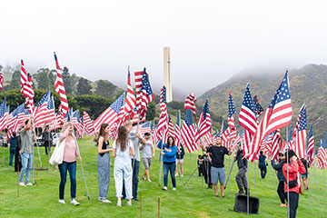 people standing with flags with tower view