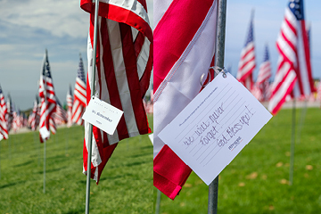 handwritten note of remembrance attached to flag