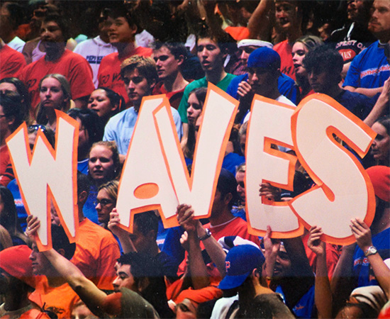 2000s alumni holding waves letters
